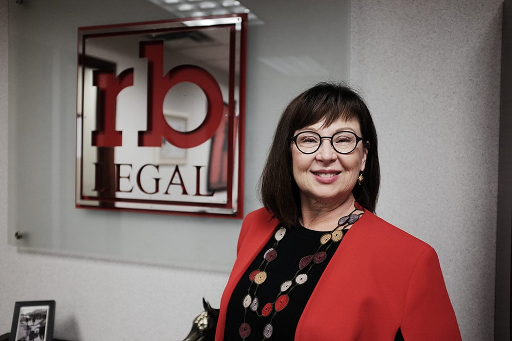 Photo of Rebecca Bell with the rb Legal logo in the background